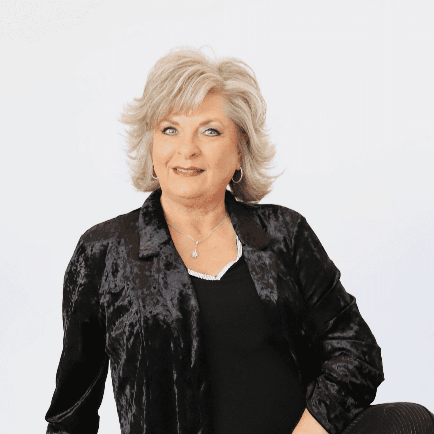 Portrait of Rhonda, a professional stylist at Shairon's Salon, showcasing their expertise and style.